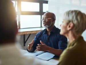 Team work, man and lady sit together in discussion on interim HR professionals