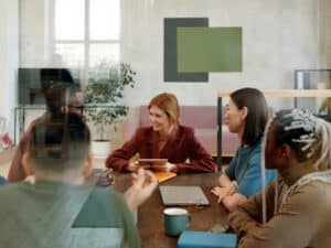 A smiling group of people at a meeting table