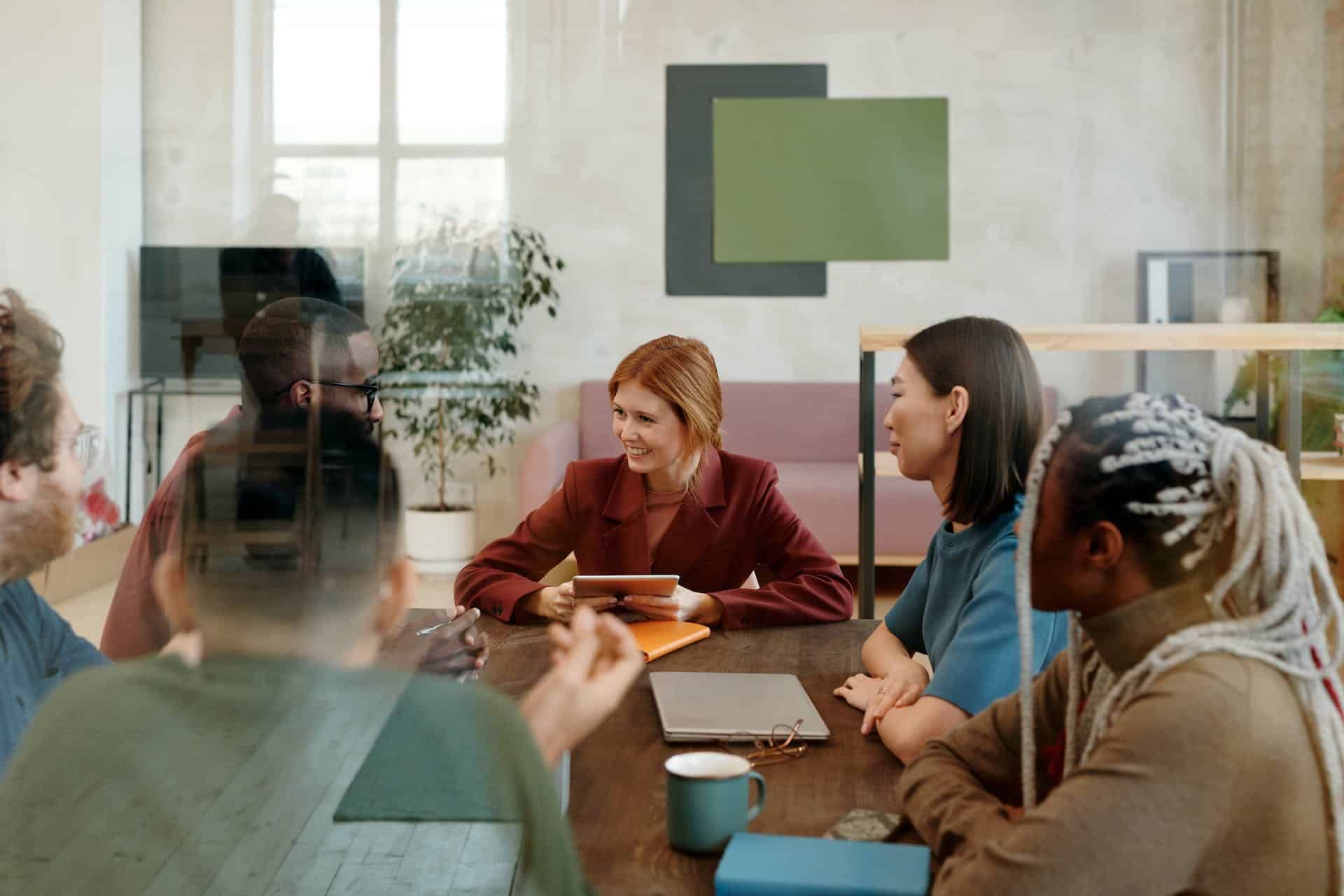 A smiling group of people at a meeting table